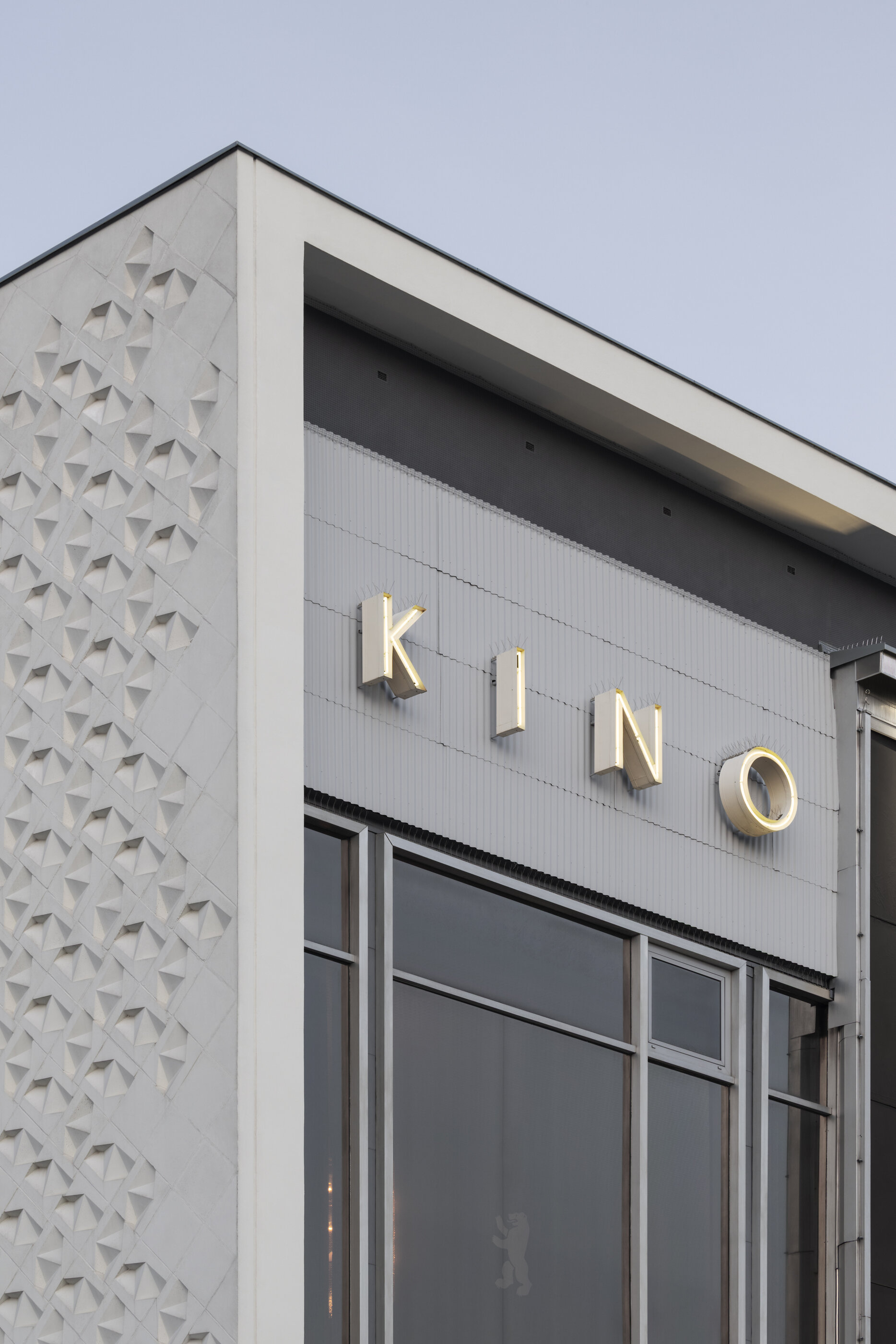 Detail of the Kino International façade with its glass front and monumental relief